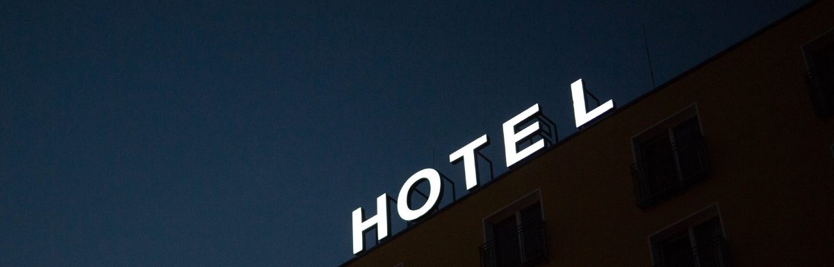 A hotel sign at night.