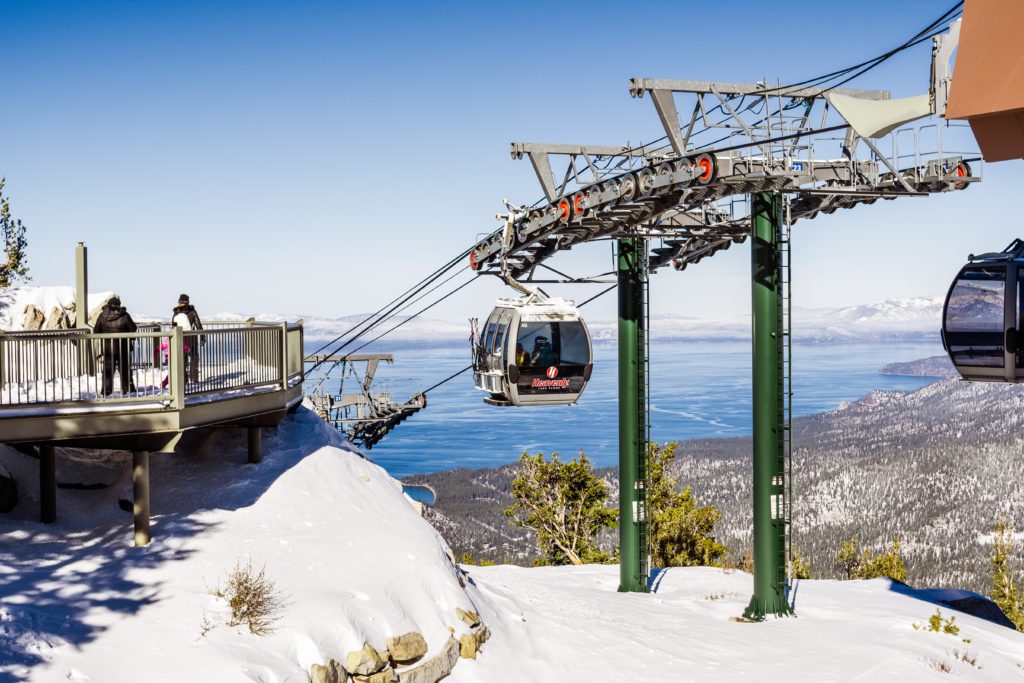 a cable car over snowy mountains