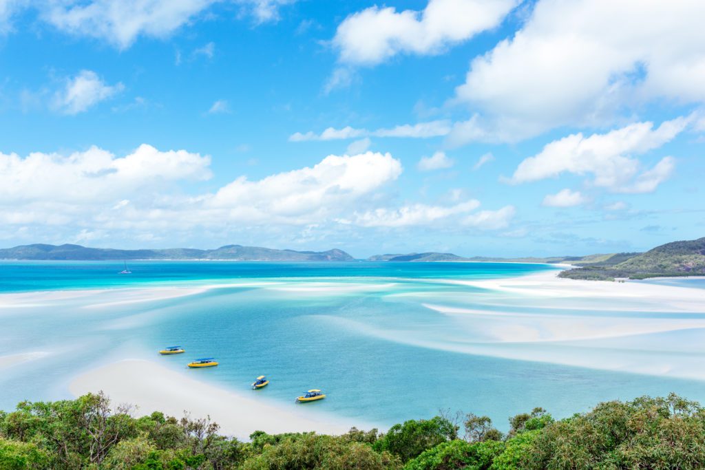 The Whitsundays, Australia - a beach with white sands and bright blue water