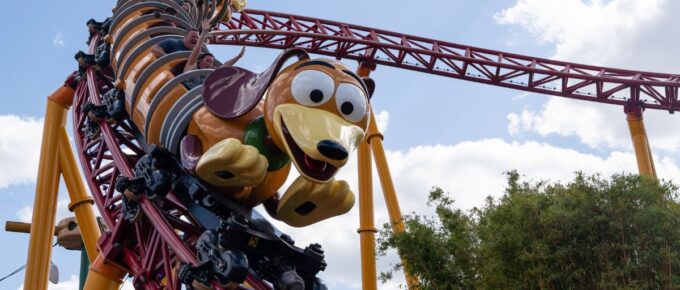 People enjoy the slinky dog dash attraction at Hollywood studios during a sunny day.