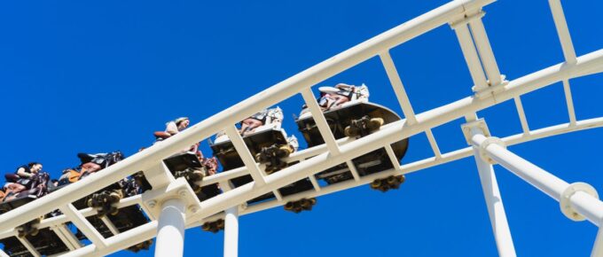 Low-angle view of people riding a roller coaster.