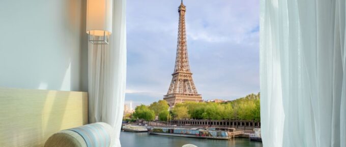 Beautiful Eiffel tower view at window in resort near Seine river, Paris, France.